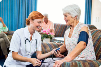 Nurse taking care of elderly woman in the retirement house