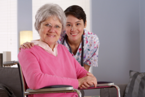 smiling caregiver and old woman