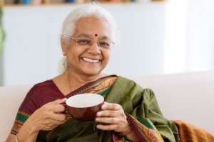 cheerful indian lady holding a cup